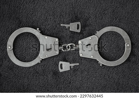 Handcuffs on a black background. Metal shackles isolated. Law. Limitation. Freedom. Security. Police bracelets                               