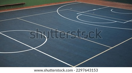 Keep calm and come shoot some hoops. an empty basketball court.