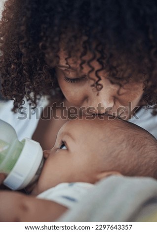 Nothing more nurturing than a mothers love. an adorable baby girl being bottle fed by her mother on the sofa at home.
