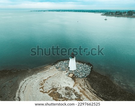 Fayerweather island light house long island sound looking towards Fairfield Connecticut beaches Royalty-Free Stock Photo #2297662525