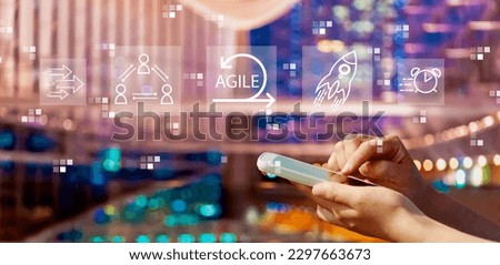Agile concept with person using a smartphone in a city at night