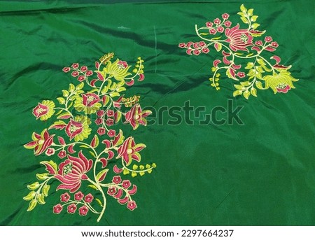 beautiful computer embroidery  design on green fabric