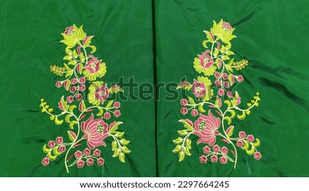 beautiful computer embroidery  design on green fabric