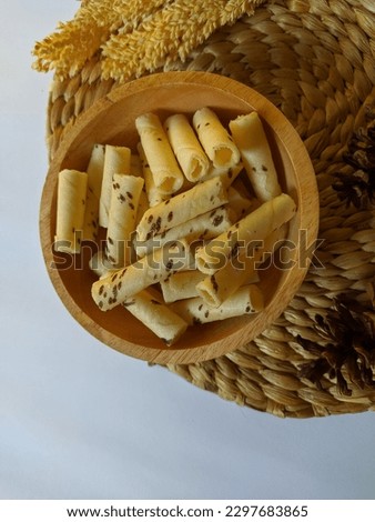 Vanilla wafer rolls in a wooden bowl. This snack is suitable for eating when relaxing
