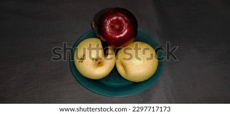 red apple and pearls on a plate