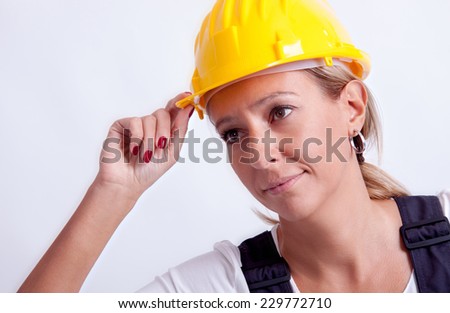 Female construction worker with tools on white background