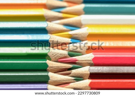 Colored pencils lie in a row. A line drawn with pencil tips. Set of crayons for illustrations, art, study. Ready for school.