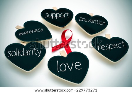 a red ribbon for the fight against AIDS and some heart-shaped blackboards with words such support, prevention, respect, love, solidarity and awareness Royalty-Free Stock Photo #229773271