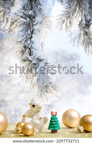Chinese new year decorations with  cute figurine baby dragon and golden balls, Winter snowy fairy forest background