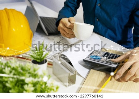 residential construction business,Using networks and teams to complete projects,Plans, calculators and helmets Royalty-Free Stock Photo #2297760141