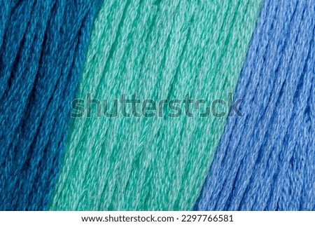Background of blue color in various pastel light shades.  No captions, blank.  Pattern structure made of strings close up