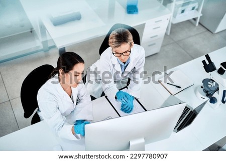 Using clinical trials and investigative methods to reach their findings. two scientists working together on a computer in a lab. Royalty-Free Stock Photo #2297780907