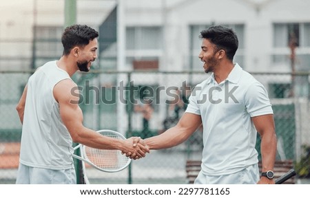 Two ethnic tennis players shaking hands before playing court game. Smiling athletes team standing and using hand gesture and handshake for good luck. Play competitive sports match for health fitness Royalty-Free Stock Photo #2297781165