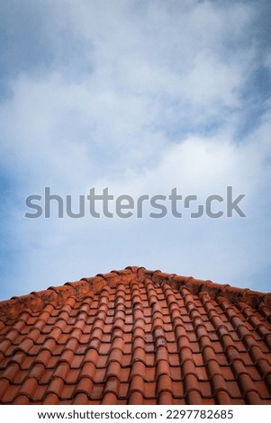 triangle house roof with red rooftile under clear blue sky. copy space