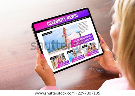 Woman reading news on tabloid website about celebrities, fashion and entertainment
