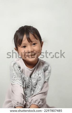 Cute and adorable expression from little girl, studio shoot, isolated in white