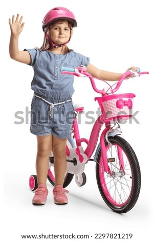 Girl with a helmet standing next to a bicycle and waving isolated on white background