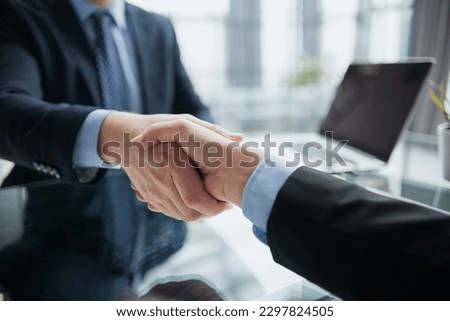 Real estate broker agent Shake hands after customer signing contract document for ownership realty purchase in the office