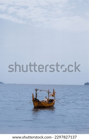 A fishing boat parked in the middle of the blue sea