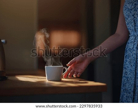 Woman is drinking coffee , morning routine. Tiny house. First property. Small apartment interior design. Minimalism. Moving in. Living alone. Charming trailer house with the morning sun Royalty-Free Stock Photo #2297835933