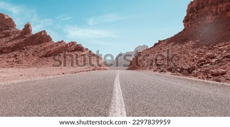 perspective straight road in desert landscape- Morocco Royalty-Free Stock Photo #2297839959