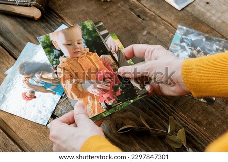 Photo printing concept. Person looking at printed photos for family picture album.