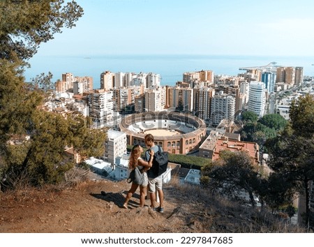 Couple of travelers enjoy the views of the Malagueta from the heights Andalucia, Spain