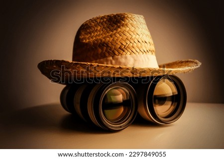 Camera lenses with hat on the top. Photography competition concept.