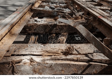 Selective focus and detail of demolish rustic railway track on old reclaimed wood railway sleepers.  Royalty-Free Stock Photo #2297850139