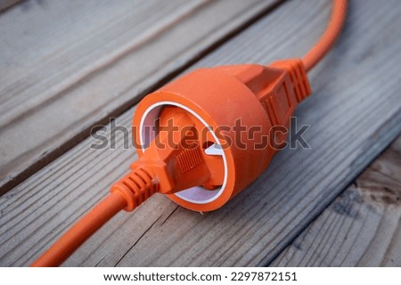 Electric wire, cable or extension cord on wood texture background. Royalty-Free Stock Photo #2297872151