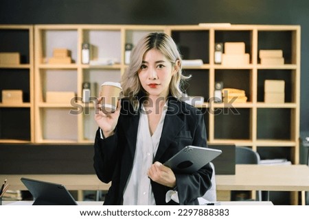 Asian businesswoman working in the office with working notepad, tablet and laptop documents in office
 