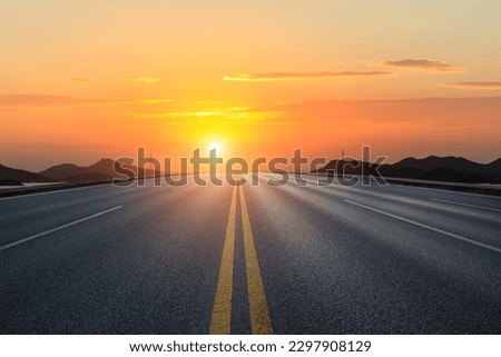 Straight asphalt road and mountain with sky clouds background at sunset Royalty-Free Stock Photo #2297908129