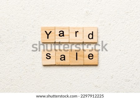 Yard sale word written on wood block. Yard sale text on cement table for your desing, Top view concept.