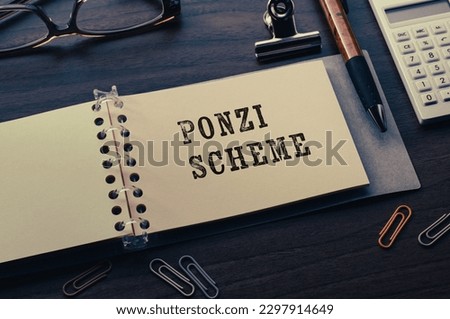 There is notebook with the word Ponzi Scheme.It is as an eye-catching image. Royalty-Free Stock Photo #2297914649