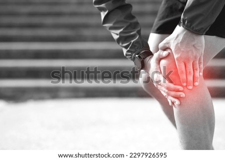 Runner touching painful twisted or broken. Athlete training, running up and down stairs accident.  Royalty-Free Stock Photo #2297926595