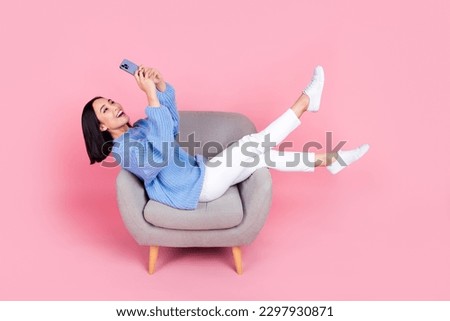 Full size portrait of pretty girl sit chair hold use smart phone chatting isolated on pink color background Royalty-Free Stock Photo #2297930871