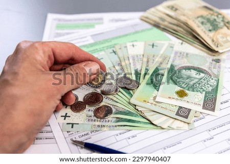Taxes, Polish banknotes and coins. PIT annual tax settlement.
