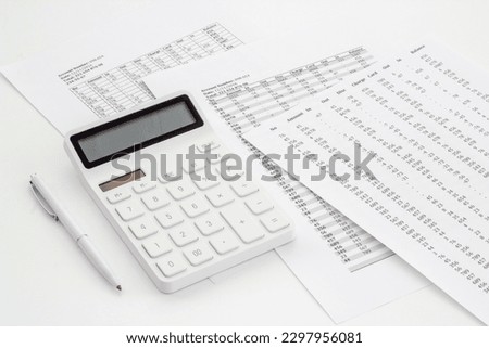 Financial accounting and report preparing with calculator on office table.