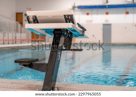 Starting block at a public interior swimming pool, natatorium sports facility. Royalty-Free Stock Photo #2297965055