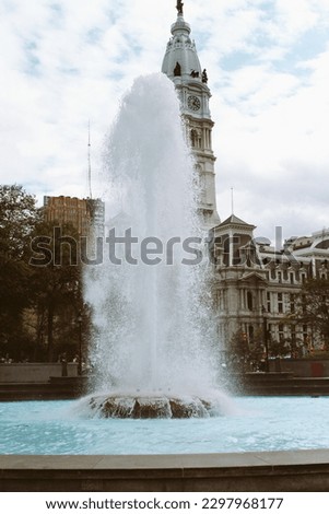 vertical high fountain against the background of an old beautiful building