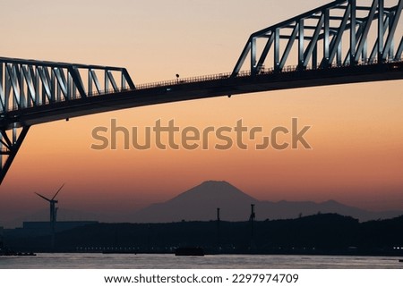 
Mount fuji silhouette under bridge at sunset