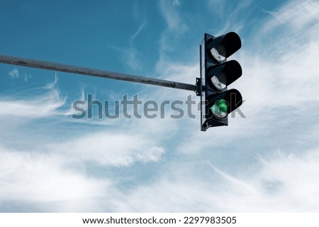 hanging traffic light against the sky  Royalty-Free Stock Photo #2297983505