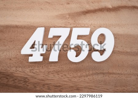 White number 4759 on a brown and light brown wooden background.