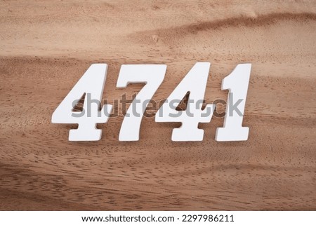 White number 4741 on a brown and light brown wooden background.