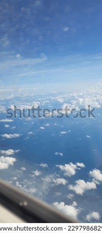 view of the blue sky with clouds from the plane