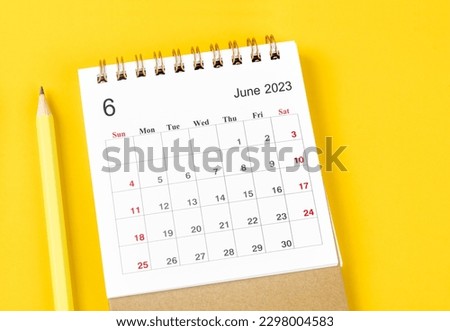 June 2023 Monthly desk calendar for 2023 with pencil on yellow background. Royalty-Free Stock Photo #2298004583