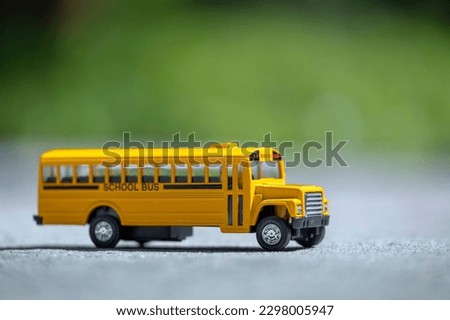 Model of classical american yellow school bus for transporting of kids to and from school every day. Concept of education in the USA