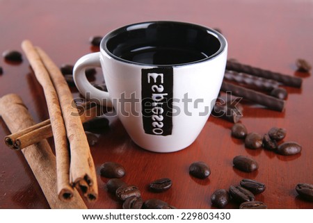 cinnamon sticks with coffee beans served on wooden tray isolated on white background