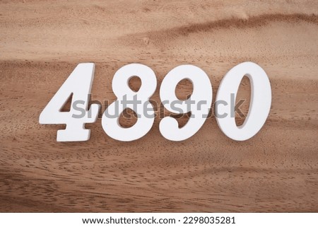 White number 4890 on a brown and light brown wooden background.