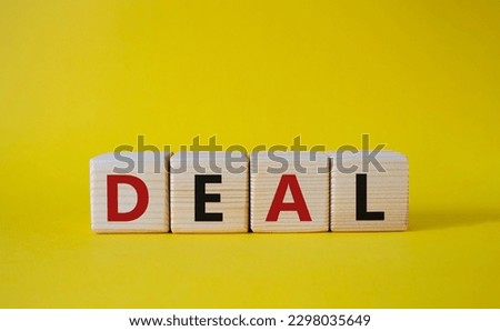 Deal symbol. Concept word Deal on wooden cubes. Beautiful yellow background. Business and Deal concept. Copy space.